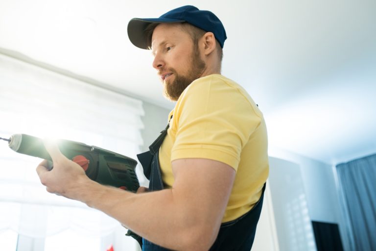 Busy handyman using power drill